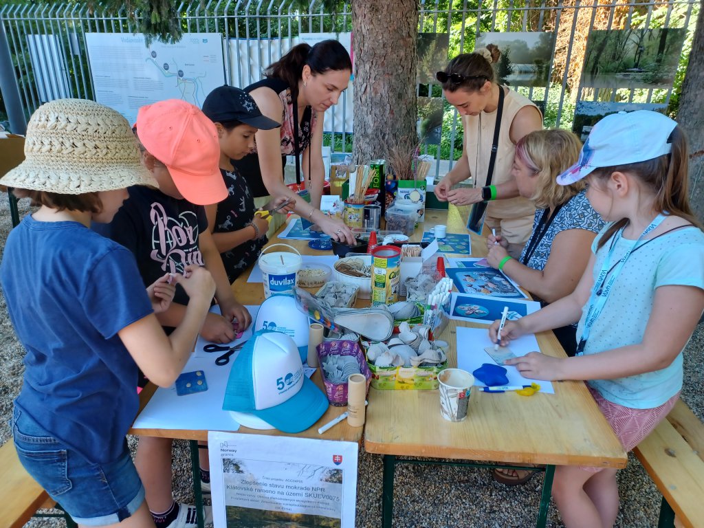 A group of kids gather around a table for arts and crafts. 