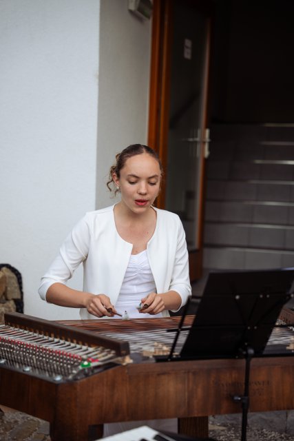 A young woman playing a cimbalom at a Danube Day event 