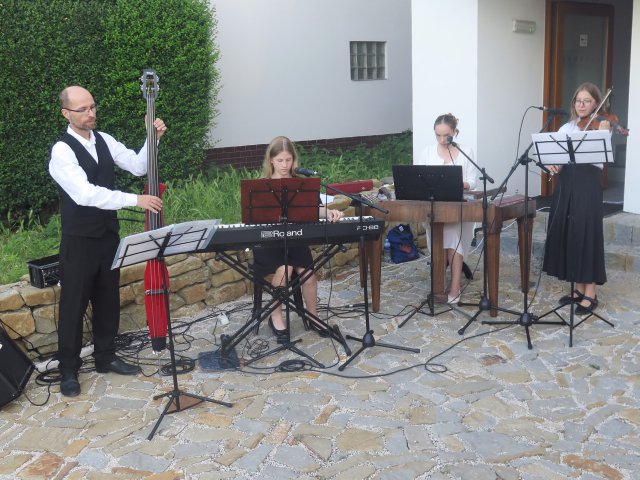 Four persons playing instruments 